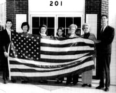 V. W. GOULD II & STAFF IN 1973 HOLDING AMERICAN FLAG